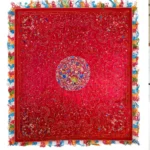 Deep red silk with a central medallion and multicoloured fringe.
