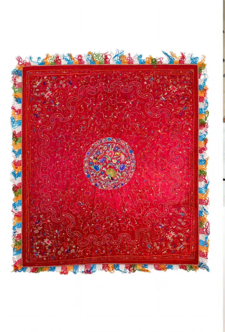 Deep red silk with a central medallion and multicoloured fringe.