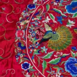 Deep red silk with a central medallion and multicoloured fringe.