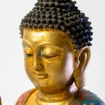 Seated Buddha, gilt face and hands, robes in cloisonné enamel.