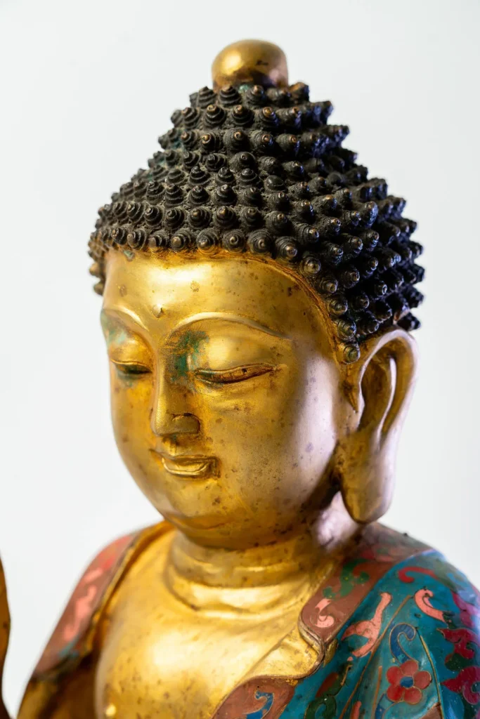 Seated Buddha, gilt face and hands, robes in cloisonné enamel.